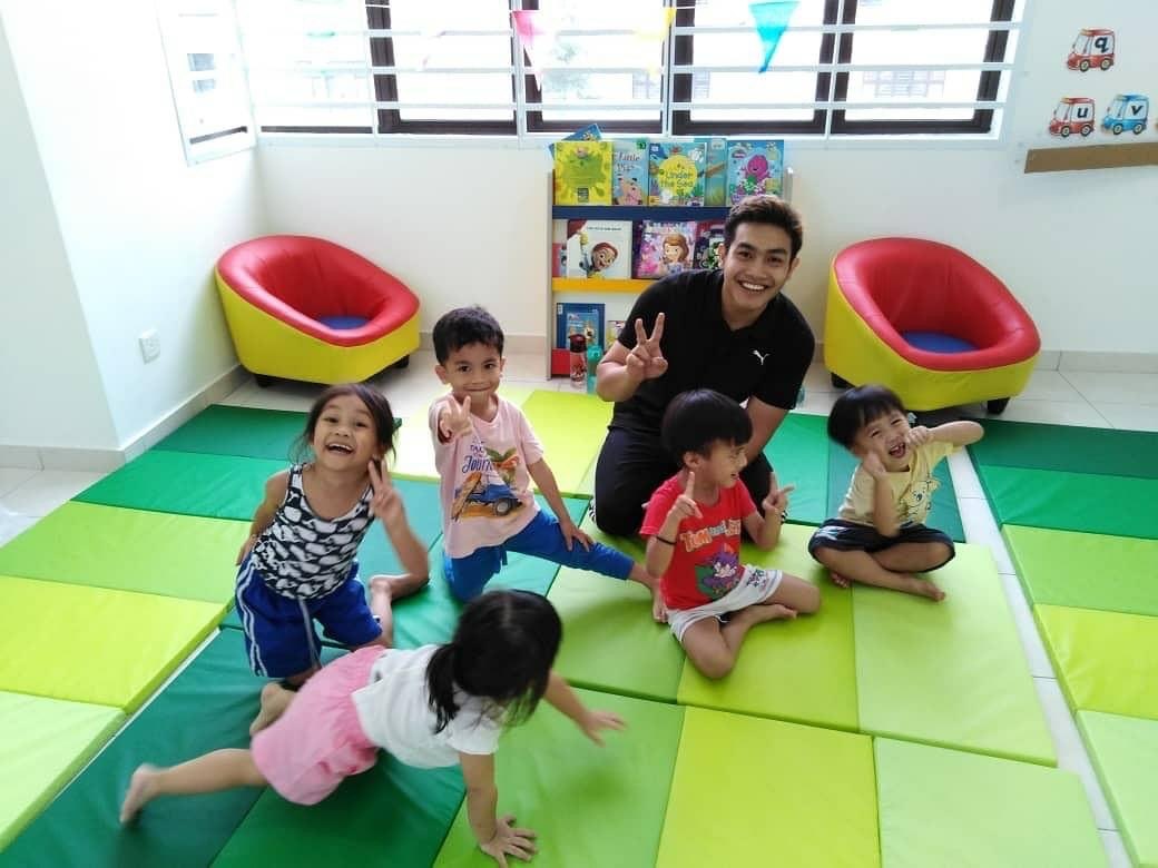 Children enjoying a relaxed moment together on colourful floor mats.